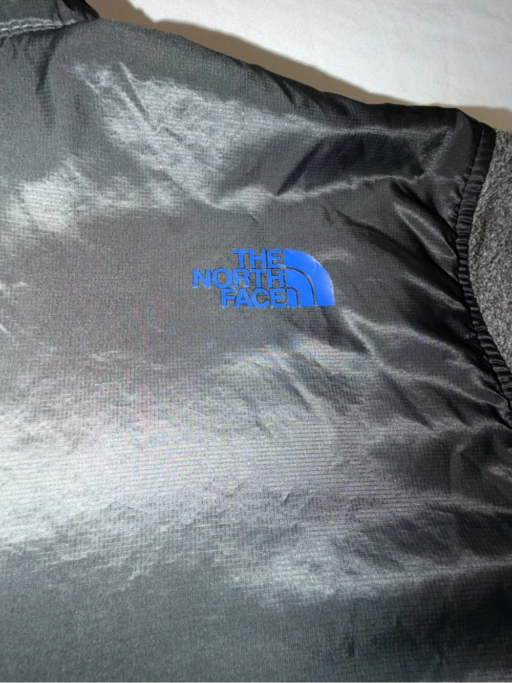 The North Face Kids Black and Gray Jacket with Blue Zip. C13,EMP